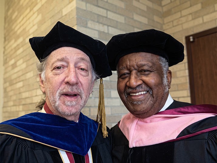 Prof. Bruce Colfin with drummer Bernard Purdie, both in academic robes
